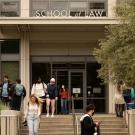 students walk up steps outside UC Davis School of Law building